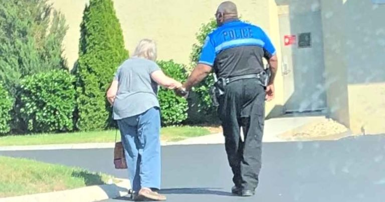 officer-helps-elderly-woman-walk