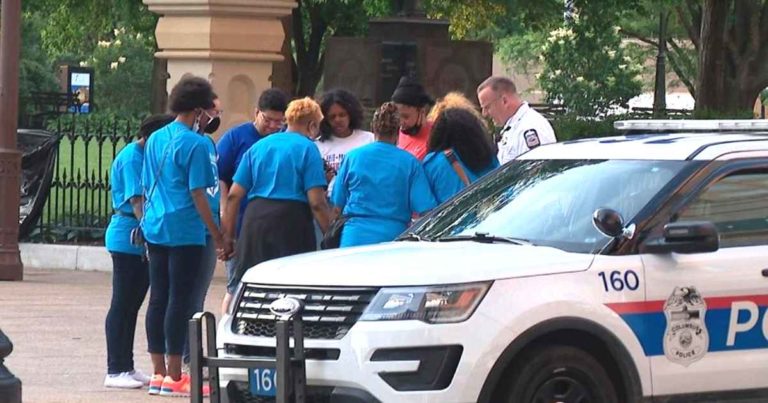 police-officer-prays-with-protesters