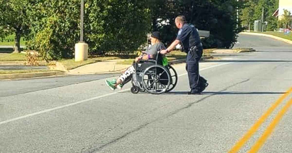police-officer-helps-man-in-wheelchair