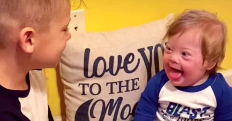 boy-singing-to-baby-brother-with-down-syndrome