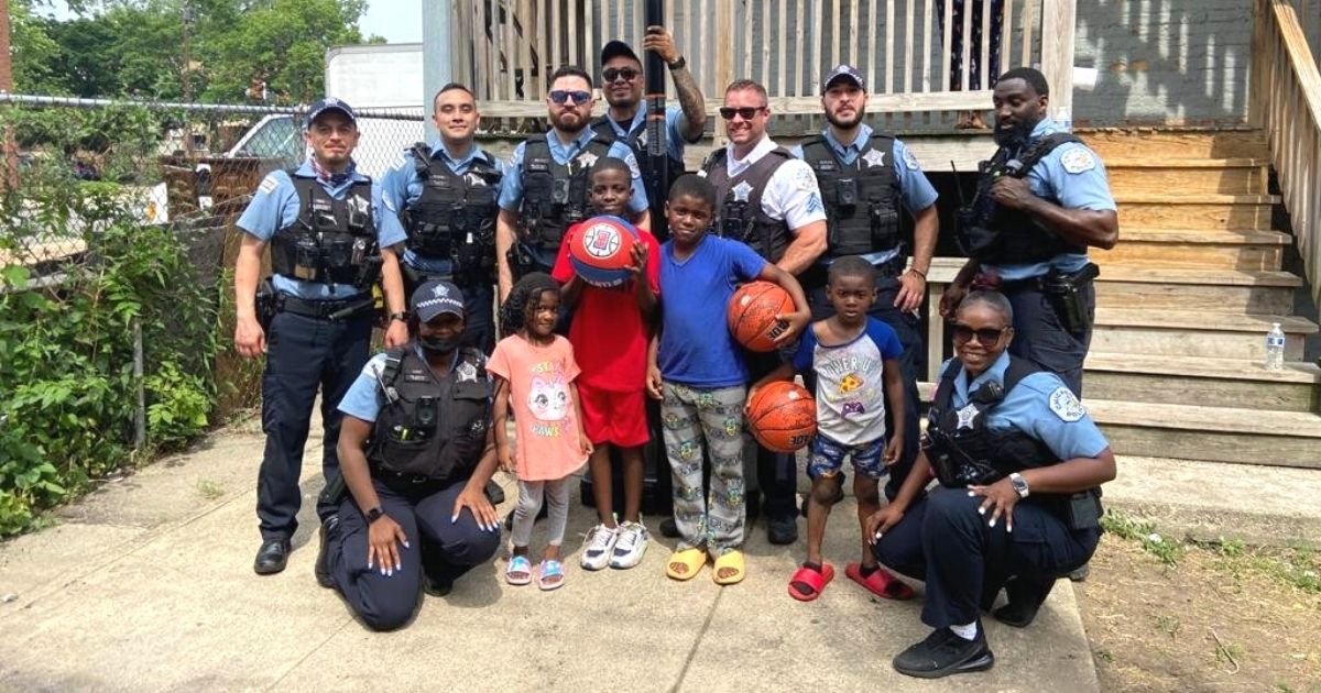 police officers give children basketball hoop