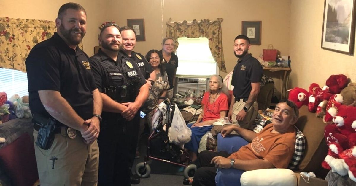 police officers help elderly woman