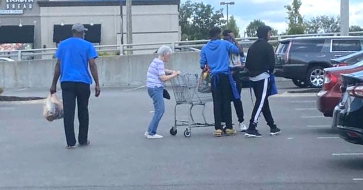 teens help elderly woman