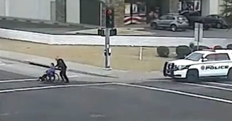 officer-helps-woman-in-wheelchair